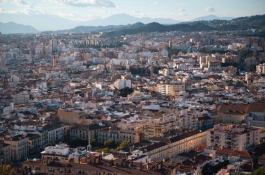 Capture the breathtaking Malaga cityscape from the hilltop fortress of Castillo de Gibralfaro. The panoramic view showcases the city's unique architecture, historic landmarks, and stunning coastline.