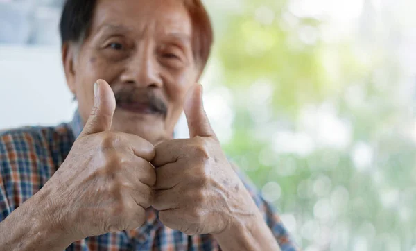 在大自然的背景下 与快乐的亚洲老人的大拇指亲密接触 有选择地注重手部 复制空间 — 图库照片