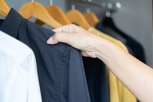 Cropped image of a business woman at hotel room who choosing clothes for work. Business, hotel, people