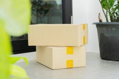 Kapıya yakın karton kutular. Paket teslimat servisi. Evin girişine yakın bir yerde teslim edilmiş. Seçici odak.