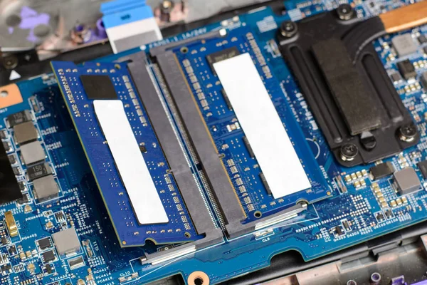 Two new RAM memory chips in the motherboard of a modern laptop. Upgrading personal computer
