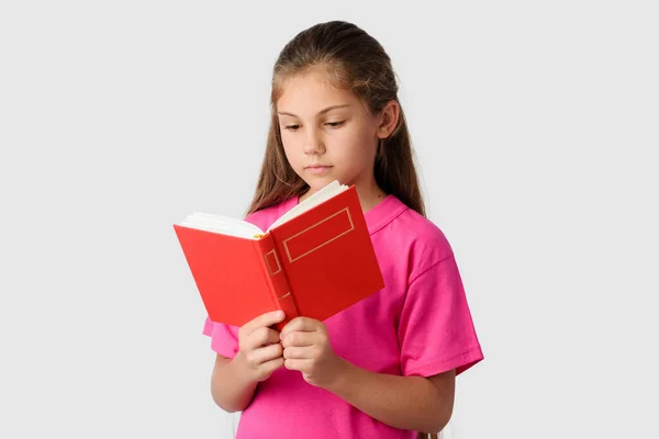 Smart Little Girl Reading Red Book Grey Background Lovely Schoolgirl — Stock Photo, Image