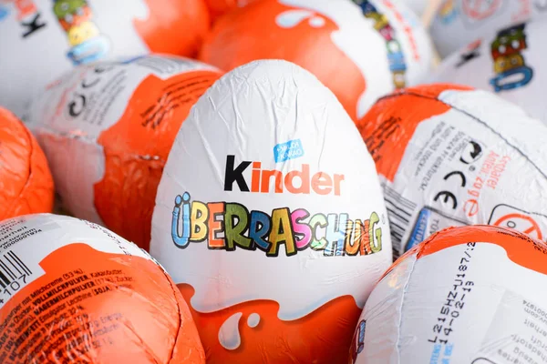 stock image Ukraine, Kiev - December 25, 2018: Kinder Surprise Egg stands between many other eggs. Chocolate egg is a sweet present by Italian confectionery manufacturer Ferrero SpA.