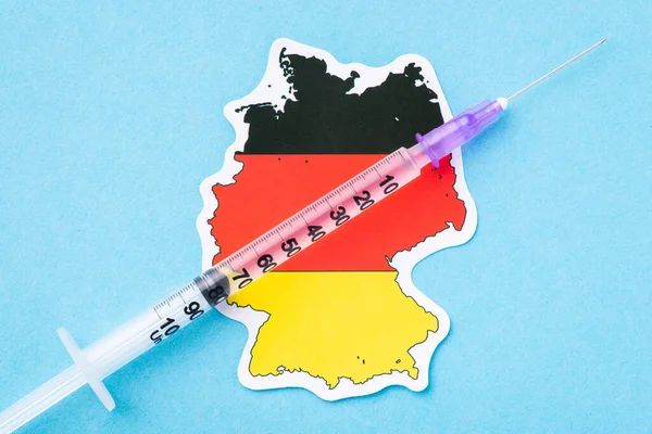 Medical vaccination in Germany. Syringe with needle full of medicine vaccine on map of Germany