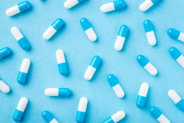 stock image Background of many blue and white pills on a blue medical background. Concept of medicine, treatment, pharmacy
