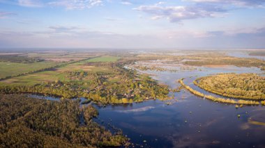 Beautiful drone photo of small village near river flooded in Spring. Valley of the river in water