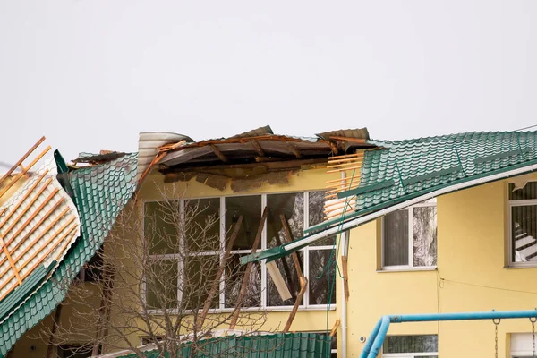 Damaged roof of a building. Strong wind, tornado, storm concept