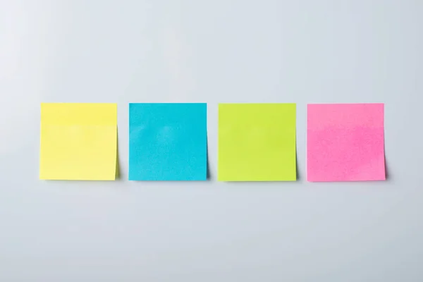 Four colorful sticky notes on a whiteboard