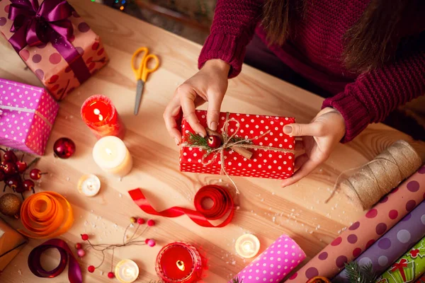 Preparation for christmas time, packing presents, creation of unforgettable surprises. Festive mood, creative atmosphere.