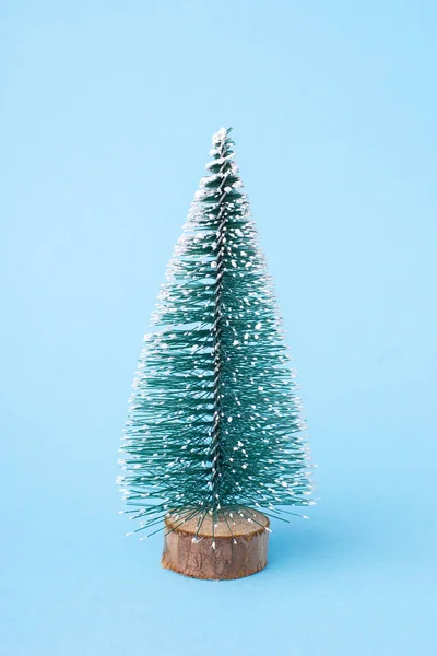 Small Christmas tree model on blue background. Christmas celebration