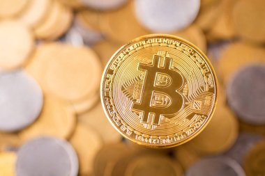 Stack of Bitcoin coins above other coins. Concept of cryptocurrency