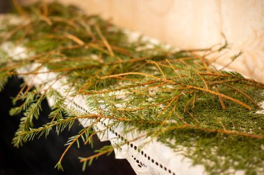 Dried christmas tree branches on the piano. Cleaning room after christmas and new year celebration, mess from fir tree needles
