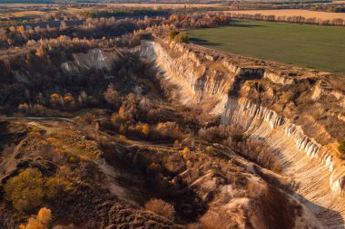 Drone point of view on chalk quarry in evening sunlight