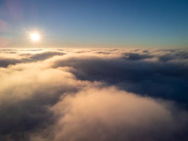 Day photo of plane flying over the clouds. Calm photo above the clouds
