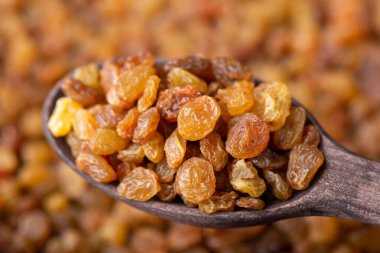 Wooden spoon with raisin. Healthy eating concept. Cooking with raisin