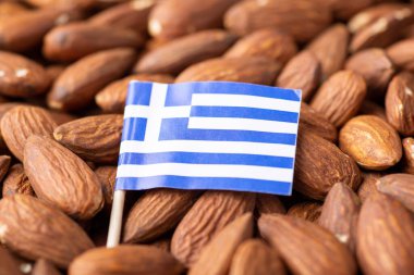 Flag of Greece on almonds. Origin of nuts, agribusiness of growing almond nuts in Greece