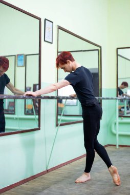 Young male dancer practicing new moves in dancing studio. Mastering dancing skills, getting ready for performance