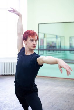 Elegant male dancer practicing new performance in dancing hall. Professional dancer during the practice