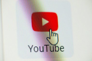 Mouse cursor clicking on YouTube icon on screen of the computer. Watching YouTube concept. Chernihiv, Ukraine - 15 January 2022