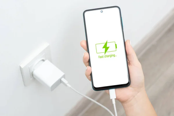 Fast charging of mobile smartphone with USB Type-C. Modern technologies, hi-tech devices, consumption of electricity