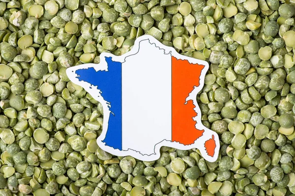 Close up shot of flag and map of France on green dry pea. Concept of growing pea in France