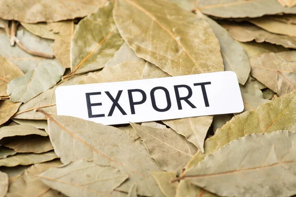 Paper with inscription Export on bay leaves. Concept of trade of bay leaves spices between countries