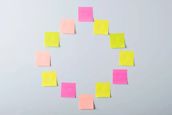 Sticky notes in a shape of a square on light a grey background. Copy space