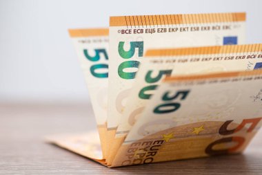 A stack of euro money on dark table close up. Banknotes of european union of 50 nominalization in focus