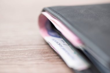 Ukrainian money in grey wallet on dark table. Concept of finance, currency and shopping