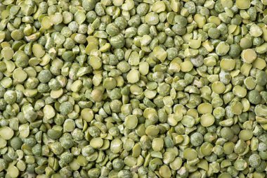 Background of green pea broken in half. Green dry pea, top-down shot. Cooking with pea