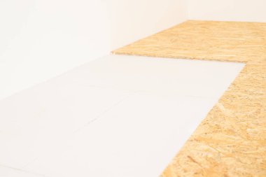 Renovating floor, warming room in progress. Warming cold concrete floor with styrofoam and wood