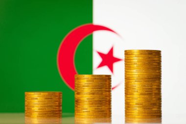 Money coins stacks in front of Algeria flag. Development of economy of Algeria concept