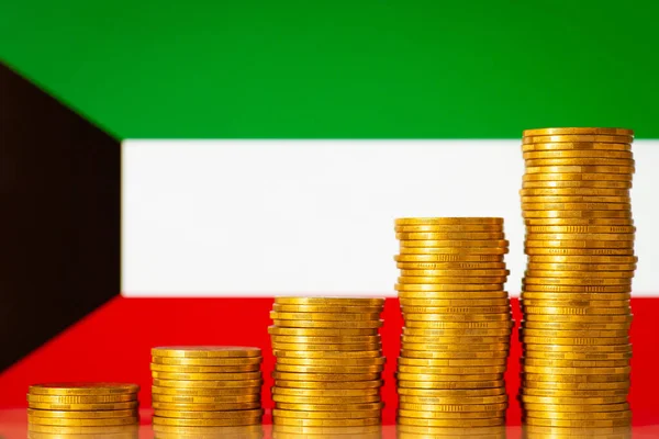Money coins stacks in rising order in front of Kuwait flag. Development of finance of Kuwait concept