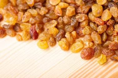 Close up of raisin on wooden table. Fresh tasty raisins on the table