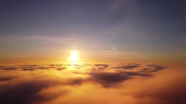 Flying high over the clouds. Aerial footage above the clouds of drone flying sideways and rotating camera smoothly to left