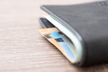 Closed wallet full of euro banknotes, close up, copy space. Concept of earning money, wealth, salary and finances