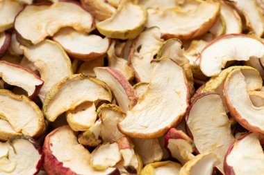 Dried apple slices as a background, top view, close up. Concept of autumn harvest, dehydrated fruits, homemade healthy food for winter