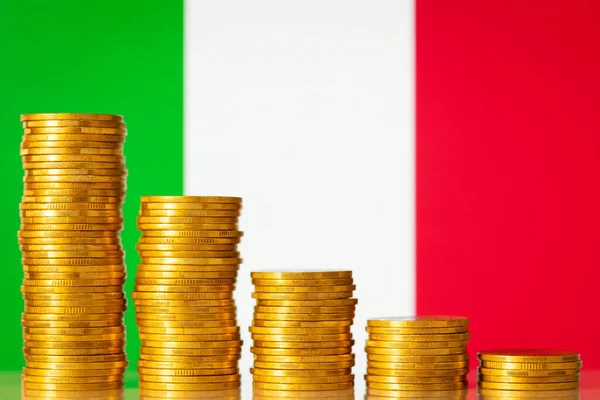 Flag of Italy with stacks of golden coins forming downcoming progression. Crisis in economy of Italy, negative process in finances of the country