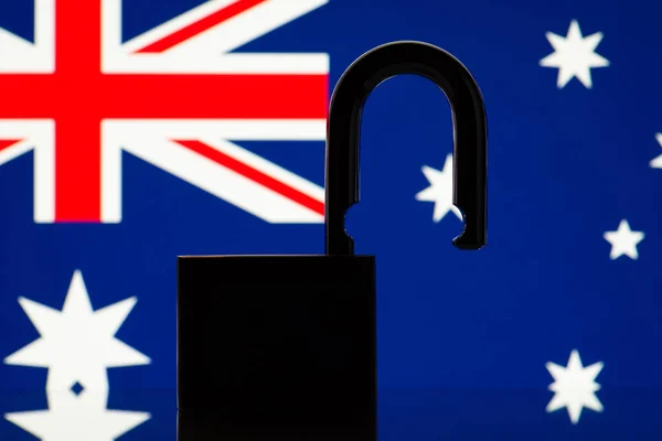 Silhouette of open lock on the background of Australia flag. Reopen country Australia, freedom, travel concept