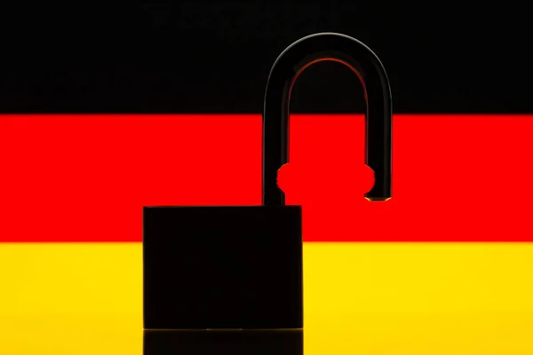 Silhouette of open lock on the background of Germany flag. Reopen country Germany, freedom, travel concept