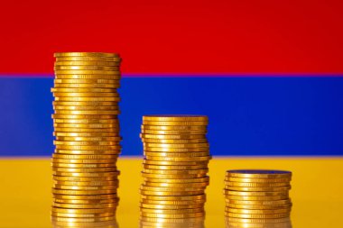 Ermenistan bayrağına karşı en yüksekten en alta üç altın sikke. Ermenistan ekonomisinde mali kriz, durgunluk