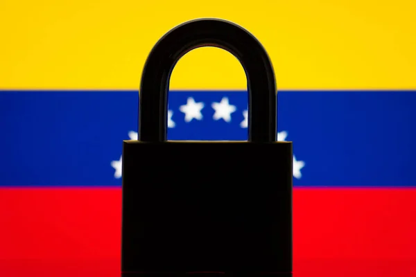 Silhouette of closed lock against flag of Venezuela. Inability to choose Venezuela country from the list, ban to enter country