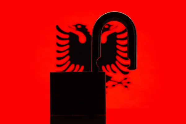 Silhouette of open lock against flag of Albania. Concept of Albania open to the world, close relationships in trade, politics with other countries