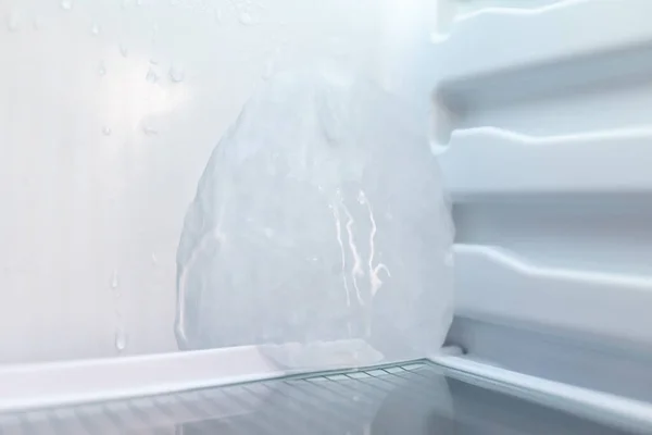 Close up of ice in fridge. Ice forming inside of fridge because of malfunction