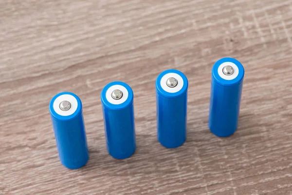 4 pieces of 18650 lithium-ion batteries on the table. Modern high capacity batteries close up