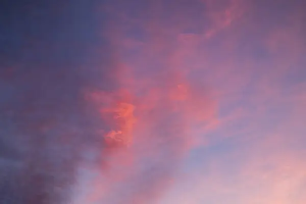 Clouds in soft pink and purple tones during sunset. Calm romantic rose sky panorama shot
