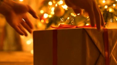 Adam yılbaşı hediyelerini Noel ağacının altına koyuyor. Akrabalara hediyeler hazırlamak, sevdiklerine hediyeler paketlemek, Noel şenliği havası.