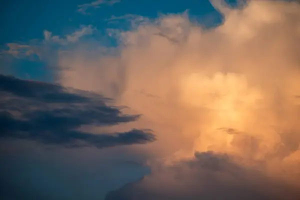 stock image Warm sunshine on the white clouds. Beautiful evening sky, picturesque view on nature at sunset