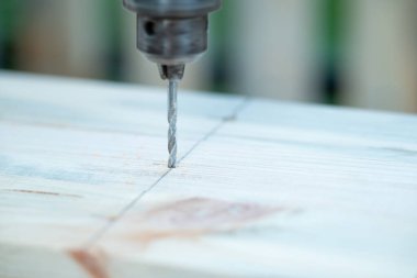 Bir matkabı kapatıp çivi deliği açmak ya da tahta bir kalasa vida takmak. El işi marangozluğu, bir şeyler inşa etmek için bir parça odun kazmak.