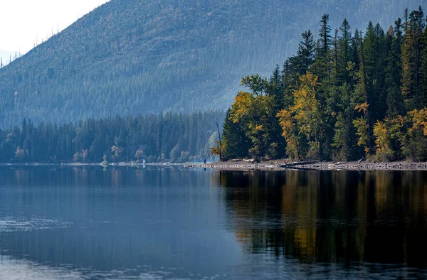 stock image A tranquil view looking across Lake MacDonald in Glacier National Park with fall colors